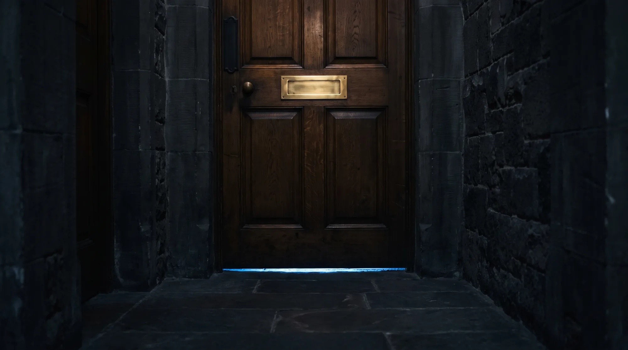A closed timber office door in a dim stone corridor. The brass nameplate at eye height is completely blank, and a thin line of light shows underneath.